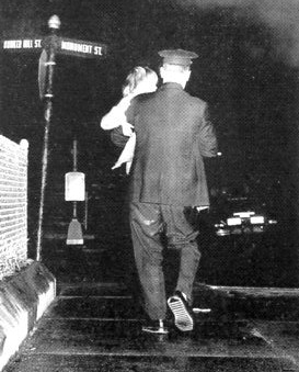 An unidentified officer is seen with a lost Charlestown toddler in 1960.